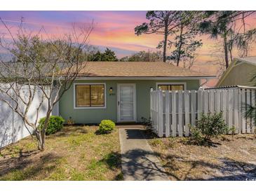 Charming single-story home with a quaint front yard, white picket fence, and inviting walkway at 1470 Turkey Ridge Dr. # D, Myrtle Beach, SC 29575