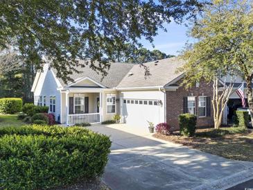 Charming single-story home featuring a well-manicured lawn and inviting front porch at 173 Knight Circle # 1, Pawleys Island, SC 29585