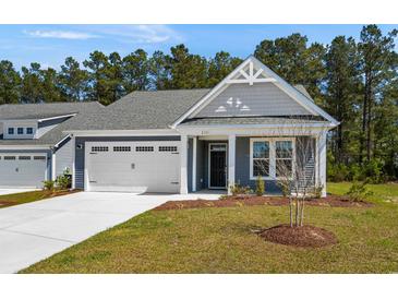 Charming single-story home with a two-car garage, a gray exterior, and landscaped front yard at 2191 Gooseberry Way, Longs, SC 29568