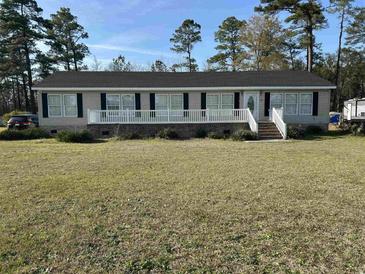 Charming single-story home with a welcoming porch and landscaped front yard at 301 Byrnes Circle, Johnsonville, SC 29555