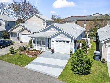 Charming single-story home with a well-manicured lawn, gray siding and an attached one car garage at 413 Chesterfield Ct., Myrtle Beach, SC 29577