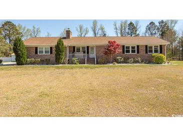 Charming one story home with brick facade, covered porch, and front yard at 7638 Highway 905, Longs, SC 29568