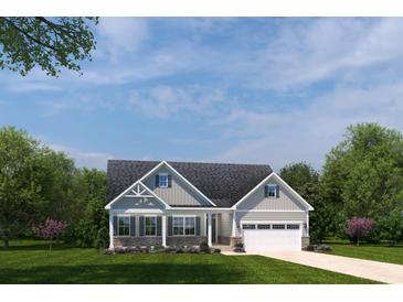 Charming home with light gray siding, stone accents, covered front porch, and a two-car garage at 767 Indigo Bay Circle, Myrtle Beach, SC 29579