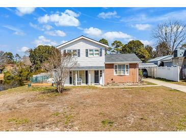 Charming two-story home featuring white siding, brick accents, and a well-manicured front yard at 806 Duncan Ave., Myrtle Beach, SC 29572