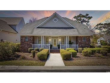 Charming single-story home with brick accents, covered front porch, and manicured landscaping at 820 Morrall Dr., North Myrtle Beach, SC 29582