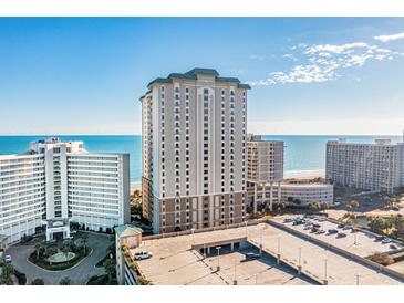 Expansive exterior shot of a beachfront high-rise condominium complex with stunning ocean views and ample parking at 9994 Beach Club Dr. # 1904, Myrtle Beach, SC 29572