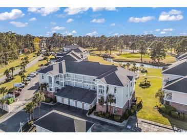 A bird's eye view of a multi-story condo building, overlooking a golf course and scenic landscape at 4827 Orchid Way # 301, Myrtle Beach, SC 29577