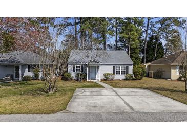 Charming single-story home featuring a well-maintained yard and a spacious concrete driveway at 6454 Sweet Gum Trail, Myrtle Beach, SC 29588