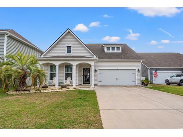 Charming single-story home with a manicured lawn and a welcoming front porch with decorative columns at 1210 Harbison Circle, Myrtle Beach, SC 29579