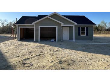 New construction home with a two-car garage, green siding and covered front entryway at 1498 Hardwick Rd., Conway, SC 29526