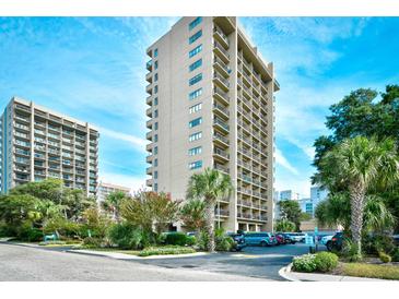 High-rise condo building boasts multiple balconies and lush landscaping under a bright blue sky at 210 75Th Ave. N # 4034, Myrtle Beach, SC 29572