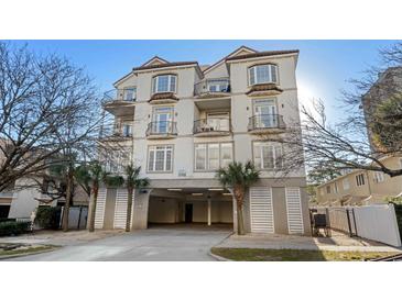 Multi-story condo building featuring private balconies and covered parking at 213 76Th Ave. N, Myrtle Beach, SC 29577