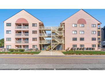 Exterior view of condo buildings with access stairs and walkway over the driveway at 2710 S Ocean Blvd. # 407-A, Myrtle Beach, SC 29577