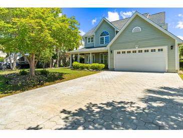 Inviting home featuring a lush yard, a spacious driveway, and an attached two-car garage at 4025 Captiva Row, Myrtle Beach, SC 29579