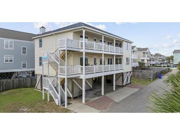 Desirable home with multi-level balconies, beautiful paint, and lovely landscaping at 412 Seaside Dr. S, Surfside Beach, SC 29575