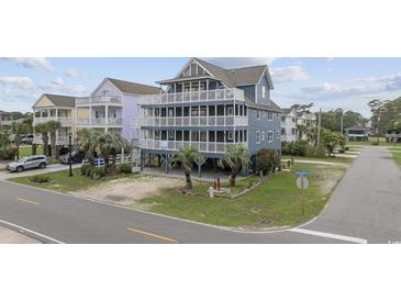 Stunning three-story beach house with multiple decks, palm trees, and ocean views, perfect for coastal living at 510 S Ocean Blvd., Surfside Beach, SC 29575