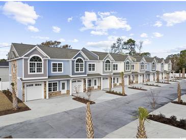 View of newly constructed townhomes showcasing colorful facades, garages and well-manicured landscaping in a friendly community at 904 62Nd Ave. N # A, Myrtle Beach, SC 29572
