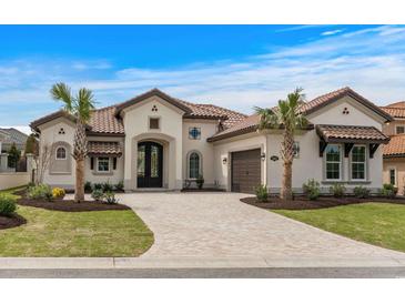 Stunning home features a tile roof, paved driveway, and a beautifully landscaped front yard at 9109 Sanremo Ln., Myrtle Beach, SC 29579