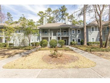 Two-story condo featuring a charming facade, well-maintained landscaping and inviting outdoor spaces at 1221 Tidewater Dr. # 1922, North Myrtle Beach, SC 29582
