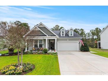 Charming single-story home with beautiful landscaping, a two-car garage, and welcoming curb appeal at 129 Astoria Park Loop, Conway, SC 29526
