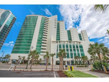 Stunning high-rise condo building featuring modern architecture, lush landscaping, and a prime oceanfront location at 201 S Ocean Blvd. # 1812, Myrtle Beach, SC 29577