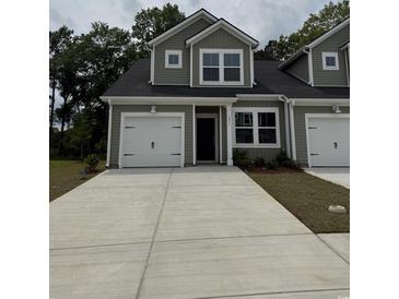 Charming two-story home with attached garage and concrete driveway, perfect for a modern living at 1211 American Shad Dr. # 36, Conway, SC 29526