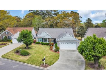 Charming single-story home boasts a well-manicured lawn, a two-car garage, and welcoming curb appeal at 1292 Merion Ct., Murrells Inlet, SC 29576