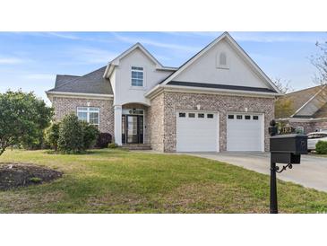Charming brick home with a two-car garage and well-maintained lawn at 1312 Ashboro Ct., Myrtle Beach, SC 29579