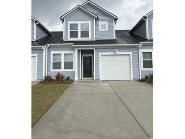 Charming two-story townhome with attached one car garage and concrete driveway at 2043 Victory Way # 516, Myrtle Beach, SC 29579