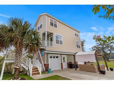 Charming home featuring a private balcony, pergola, and ample parking with a well manicured lawn at 4387 Landing Rd., Little River, SC 29566