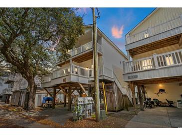 Two-story beach home featuring classic coastal architecture with elevated structure and private balconies at 6001 - 1125 S Kings Hwy., Myrtle Beach, SC 29575