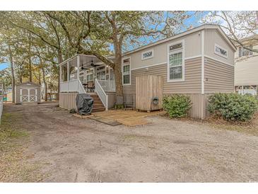 Charming home exterior with an outdoor shower, porch, and storage shed at 6001-Mh26 S Kings Hwy., Myrtle Beach, SC 29575