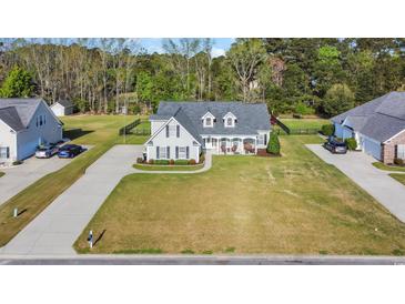 Stunning exterior view of a two-story home with a landscaped yard and a welcoming front porch at 124 Mesa Raven Dr., Longs, SC 29568