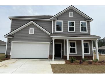 Charming two-story home with a two-car garage and inviting front porch at 1304 Winding Creek Way, Myrtle Beach, SC 29588
