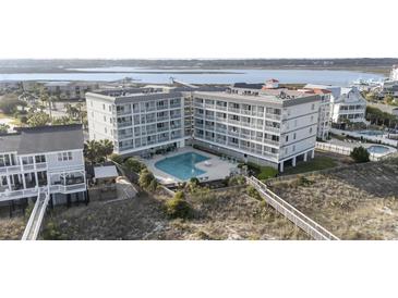 Coastal condo complex boasts balconies, a shared pool, and beach access with stunning ocean views at 1581 S Waccamaw Dr. # 303, Murrells Inlet, SC 29576