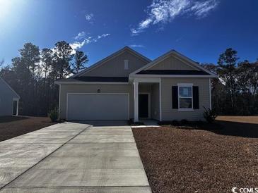 Charming single-Gathering home featuring a two-car garage and landscaped front yard at 623 Castillo Dr., Loris, SC 29569