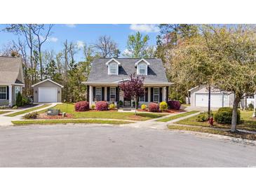 Charming home with black shutters, dormers, mature landscaping, and detached garage at 3255 Gervais Ln., Myrtle Beach, SC 29588