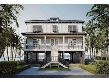 Stunning coastal home with a stilt foundation, spacious porch, and views of the ocean at 428 Vista Dr., Murrells Inlet, SC 29576