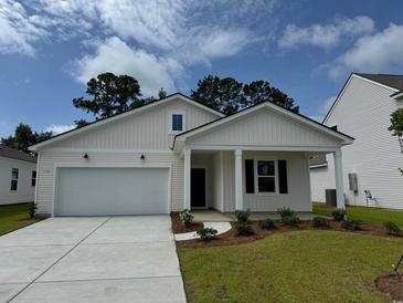 Charming one-story home with a well-manicured lawn, garage, and inviting entrance at 1031 Laconic Dr., Myrtle Beach, SC 29588