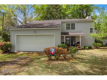 Charming two-story home featuring a two-car garage and a cozy front porch at 1213 Oak St., Conway, SC 29526