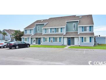Attractive condo featuring blue shutters, gray paint, and parking in front of each unit at 1891 Colony Dr. # 15E, Surfside Beach, SC 29575