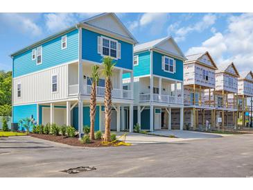 Stunning two-story beach home featuring blue and white exterior and coastal charm at 2309 Seaseeker Ln., Myrtle Beach, SC 29577