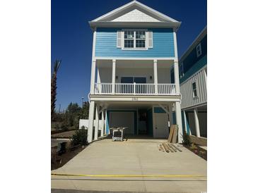 New construction home with blue siding, white trim, and a spacious covered parking area at 2309 Seaseeker Ln., Myrtle Beach, SC 29577