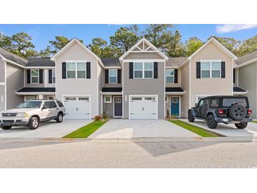 Charming townhomes with unique exteriors, driveways, and attached one-car garages at 247 Christiana Ln. # D, Myrtle Beach, SC 29579