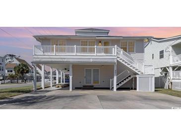 Charming two-story home with a balcony and staircase leading to the first level at 301 58Th Ave. N, North Myrtle Beach, SC 29582
