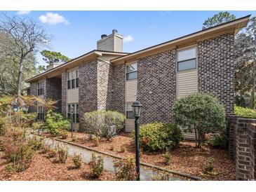 Charming brick and siding condo with well-maintained landscaping and mature trees at 404 75Th Ave. N # E, Myrtle Beach, SC 29572