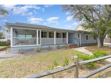 Charming single-story home with a large screened front porch and well-maintained lawn at 600 Hillside Dr. S, North Myrtle Beach, SC 29582