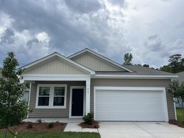 Charming single-story home with neutral siding, a two-car garage, and freshly landscaped front yard at 615 Muster Field Ct., Conway, SC 29526