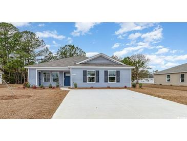 Charming single-story home with blue siding, a gray roof, and a well-maintained front yard at 620 Culmen Ct., Myrtle Beach, SC 29588