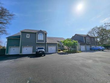 Attractive two-story exterior with individual garages and a blue car parked in the parking lot at 800 Castleford Circle # 1-E, Myrtle Beach, SC 29572
